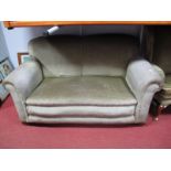 A Circa 1920's Two Seater Drop Arm Settee, upholstered in celadon velvet, on castors.