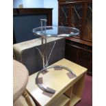 A Contemporary Chrome and Glass Adjustable Side/Coffee Table, from a famous design.