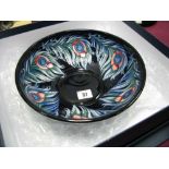 A Moorcroft Pottery Shallow Bowl, tubelined and decorated in the Peacock Feather design by Rachel