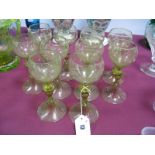 A Set of Ten Early XX Century Continental Amber Hock Glasses, each with a vine etched bowl, on a