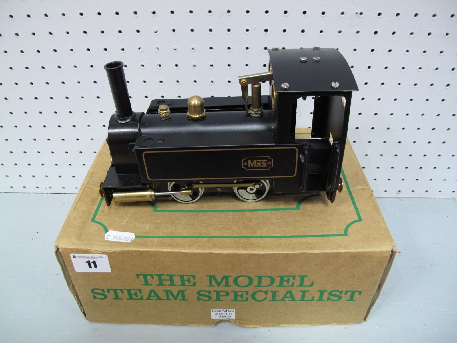 A Mamod/M55 0-4-0 Live Steam Locomotive, finished in black and gold, appears un-steamed. In