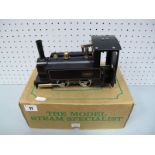 A Mamod/M55 0-4-0 Live Steam Locomotive, finished in black and gold, appears un-steamed. In