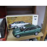 A Boxed U.T. Models 1:18 Scale Diecast BMW 328i, in metallic green.