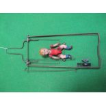 A Mid XX Century Japanese Celluloid Clockwork Doll, on a trapeze. Appears complete but with signs of