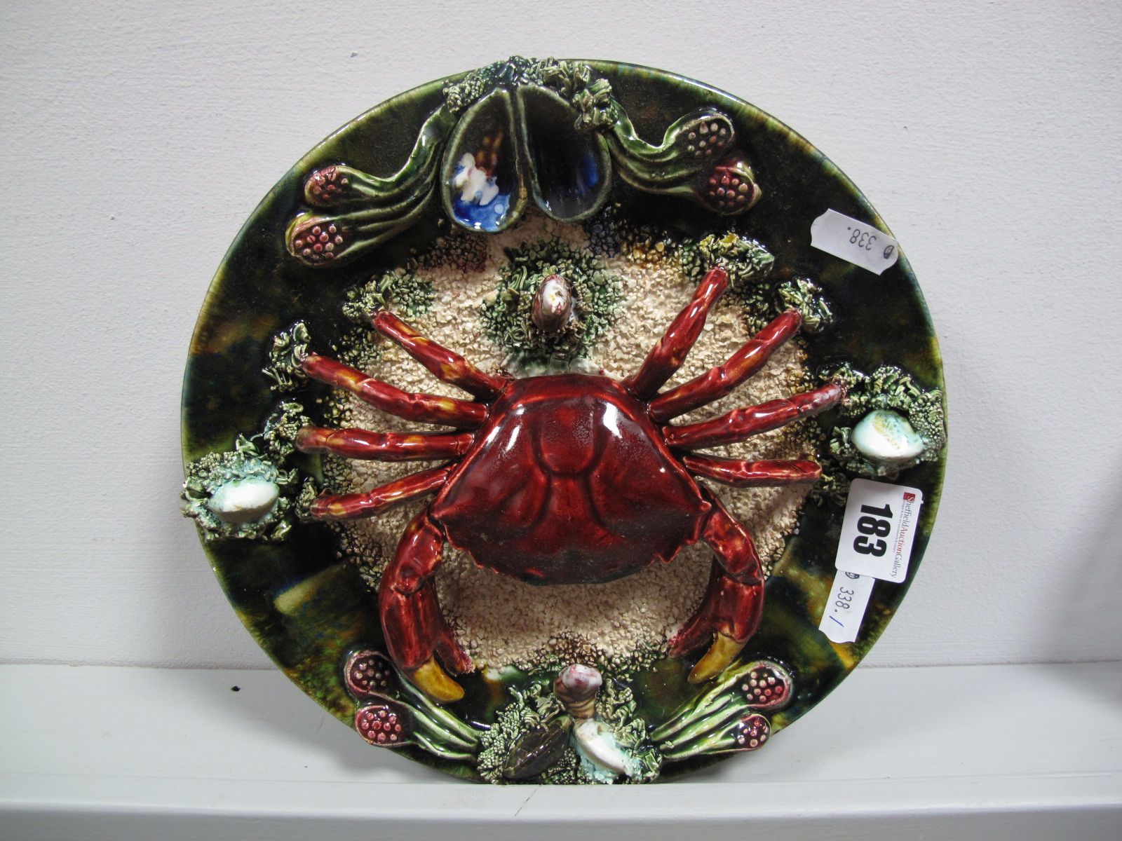 A XX Century Palissy Style Majolica Wall Plate, modelled with a red crab on shredded and encrusted
