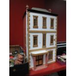 A XX Century Georgian Style Three Storey Dolls House, sash windows with quoin stonework and porch,