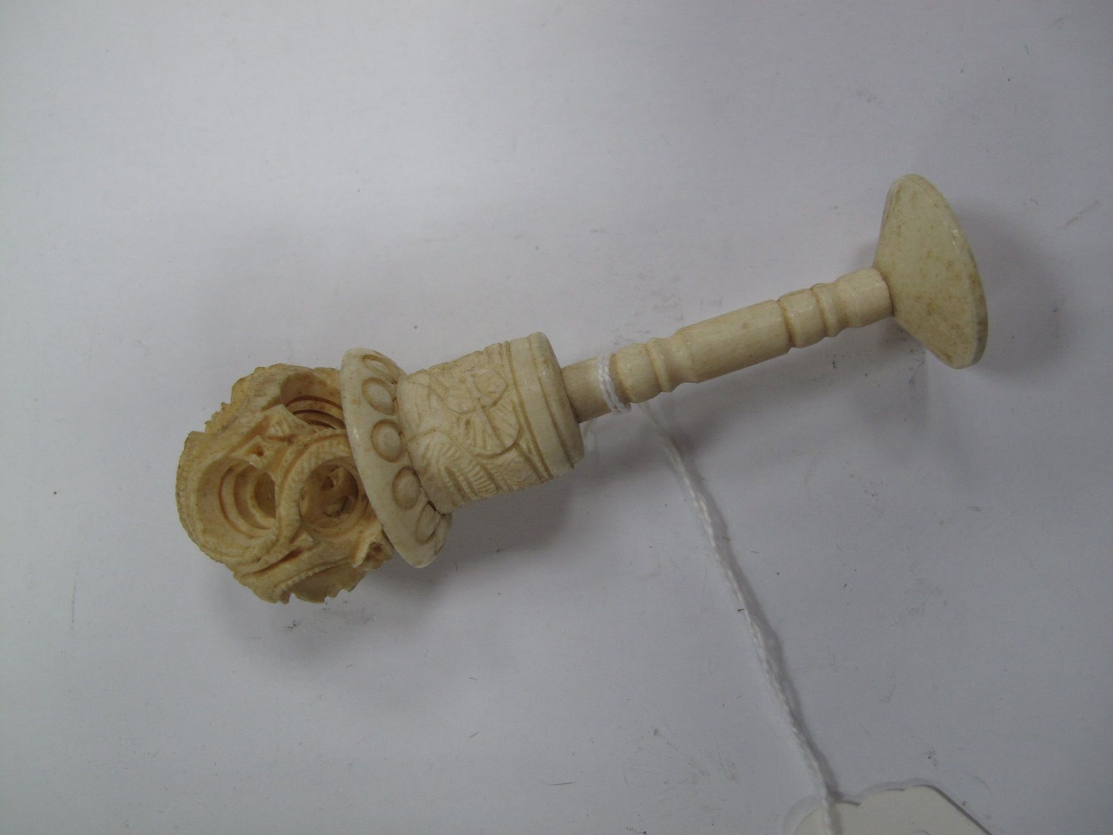 Carved Bone Concentric Balls, on turned support.
