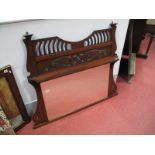 An Early XX Century Walnut Overmantel, with a pierced frieze over a shaped shelf, bevelled glass