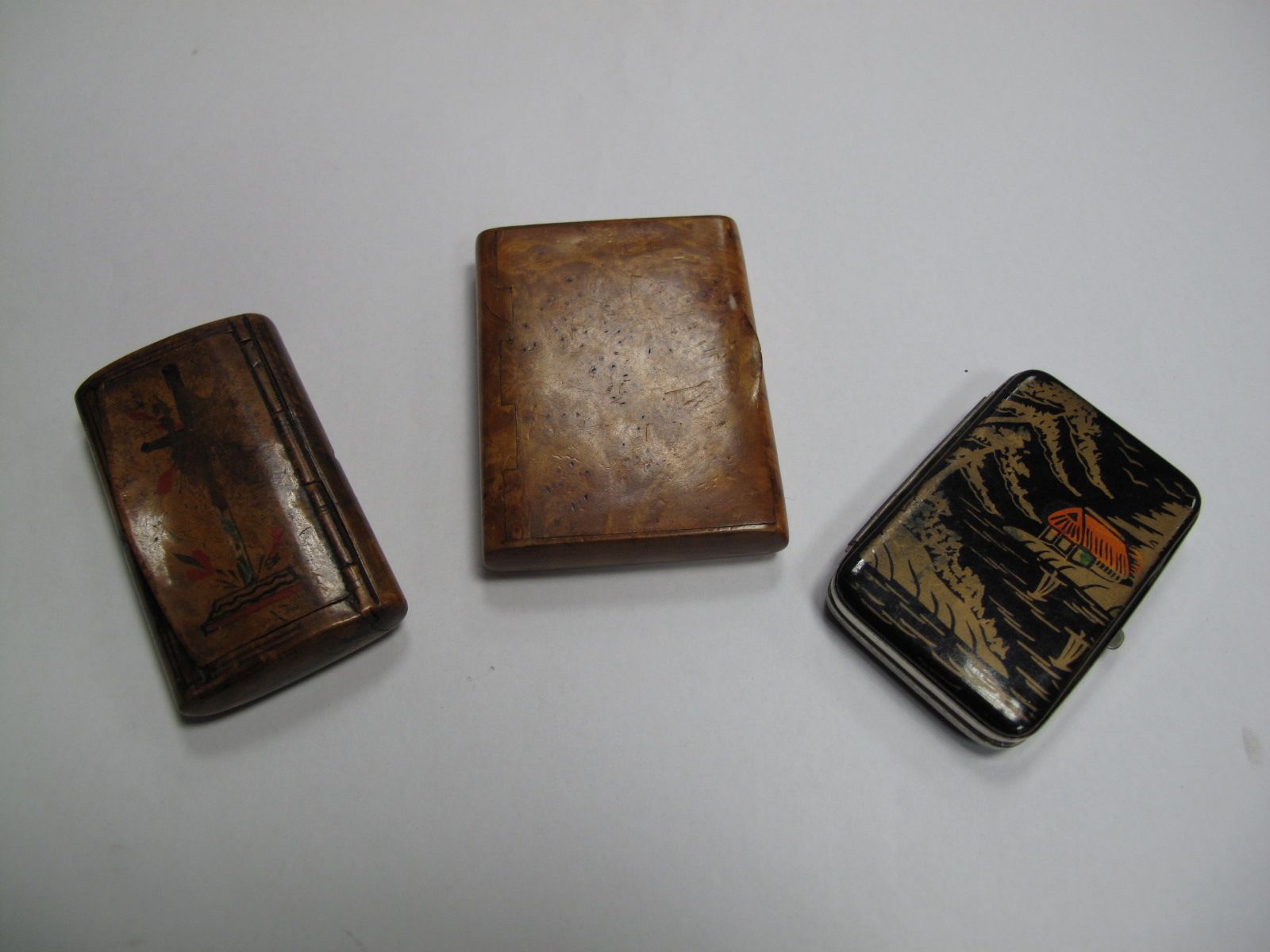 A XIX Cushion Shape Snuff Box, another in birds eye, maple, an Oriental cigarette case.