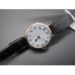 A 9ct Gold Cased Wristwatch, the white dial with black and blue Arabic numerals, within case with