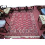 Tuerka Wool Tasseled Rug, with allover motifs on a red ground, 210 x 145cms.