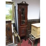 An Early XX Century Stained Mahogany Double Corner Cupboard, with an applied pediment, glazed