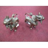 A Pair of Nepalese Brass Temple Lions, XX Century, 17cms high.