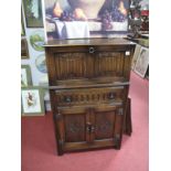 A XX Century Oak Cocktail Cabinet, with a linen fold panelled front, single drawer, with knulled