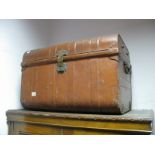 A XIX Century Brown Painted Tin Trunk, with a domed top, and with carrying handles.
