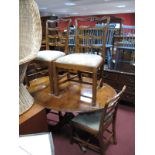 Yew Wood Oval Shaped Dining Table, together with four ladder back dining chairs.