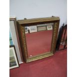 An Early XX Century Gilt Framed Rectangular Wall Mirror, with bead, foliage and ribbon tie moulded