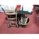 An Early XX Century Oak Sack Barrow, a woven can twin handled basket, stool, further basket and