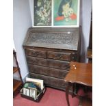 XIX Century Oak Bureau, with floret and mythological beast carving to fall front, and half wheel