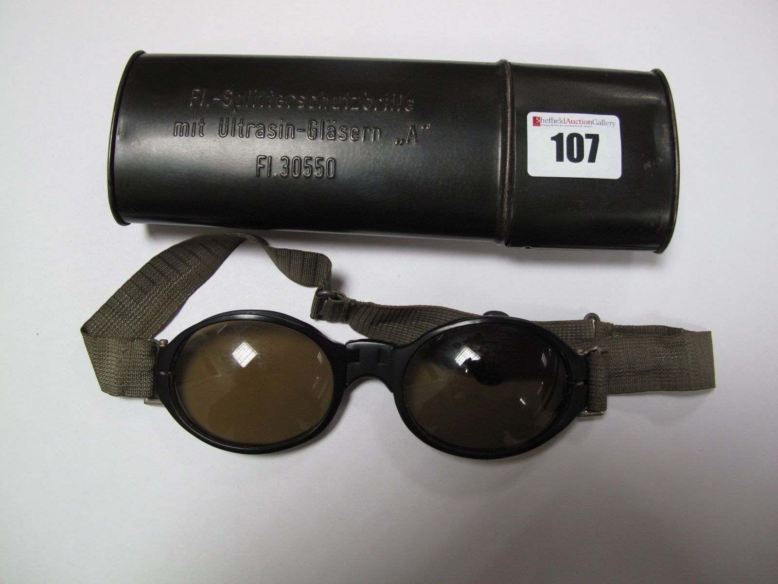 A Mid XX Century Pair of German Tinted Flying Goggles, in original tin. Tin stamped F1- Splitter