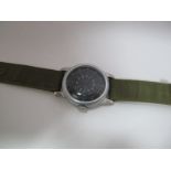 A Second Half XX Century US Military Wristwatch by Waltham, the black dial with Arabic numerals, the