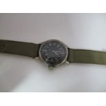 A WWII Era American Military Wristwatch by Bulova, the black dial with Arabic numerals, the case