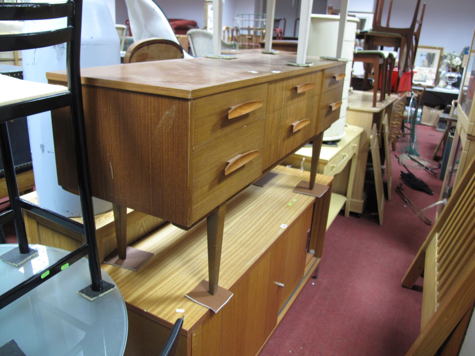 A 1960's Teak Sideboard, having six short drawers to frieze on square tapering legs.