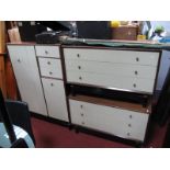 E Gomme G Plan Two Cream Fronted Teak Chests, of three drawers and tallboy, all on black squat