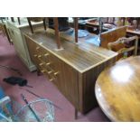 A 1960's Teak Sideboard, having four central drawers and flanking cupboard doors, on splayed
