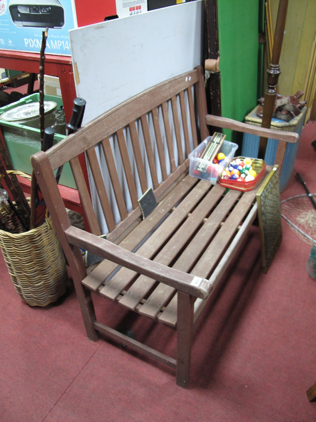 A Wooden Garden Bench, latts, back and seat with shaped open arms.