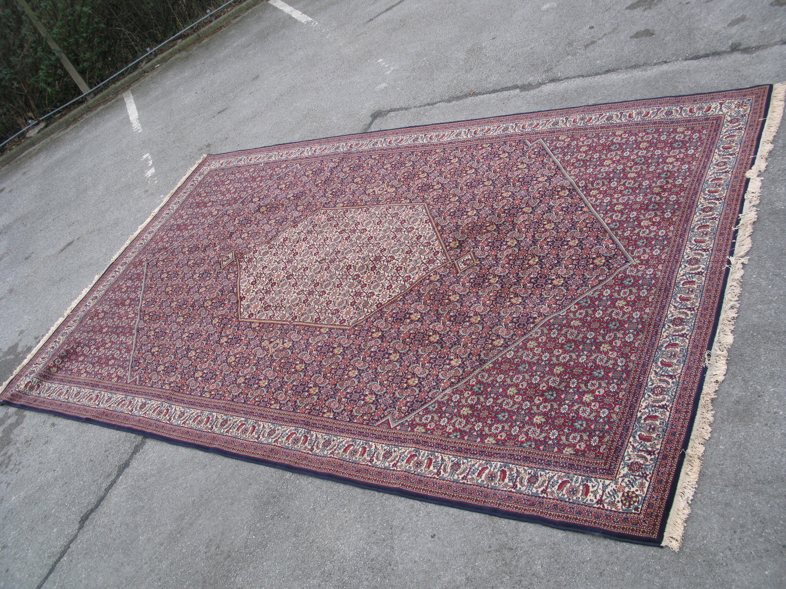 A Large Persian Style Carpet, central lozenge motif within larger lozenge, all over heavy stylised