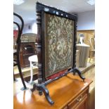 A XIX Century Firescreen, with foliate woolwork tapestry centre.