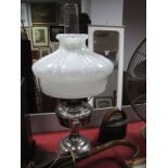 A Chrome Bodied Oil Lamp, with decorative white glass shade and an early 1900's Otto gas iron.