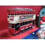 A Modern Tinplate Model of a 1903 Tram, adorned with advertising stickers, destination Altrincham,