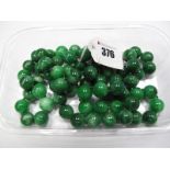 A Long Single Strand Polished Green Hardstone Bead Necklace, the uniform beads knotted.