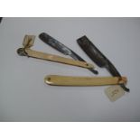 A c.1820 Cutthroat Razor, ivory scales, with foliate cap and inlaid shield, 3/4" blade, jimped