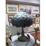 Tiffany Style Table Lamp, with a leaded glass shade, on a soft metal base, with reeded decoration.