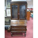 An Early XX Century Oak Bureau Bookcase, press stamped geometric and scrolled frieze over twin