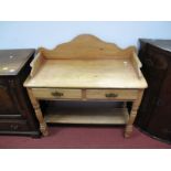 A Late XIX Century Pine Washstand, with shaped gallery twin drawers, lower pot shelf, on turned