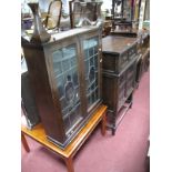 A 1920's Oak Cabinet, with lead glazed doors, on barley twist legs. A similar slender cabinet (