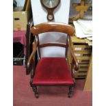 A XIX Century Mahogany Carver Chair, with a shaped top rail, shaped arms, drop in seat, on turned