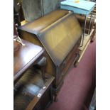 A Mid XX Century Walnut Bureau, with a fall front, fitted interior, two long drawers on cabriole