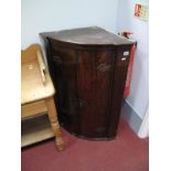 A XIX Century Oak Corner Wall Cabinet, with cylinder front and three painted inner shelves.