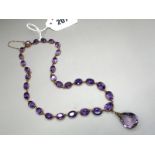 An Amethyst Set Necklace, of graduated design, to snap clasp, suspending faceted drop.