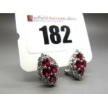 A Pair of Modern 18ct White Gold Ruby and Diamond Set Earrings, of marquise shape, each claw set