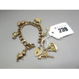 A 9ct Gold Curb Link Bracelet, to 9ct gold heart shape padlock clasp, suspending novelty charm