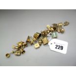 A 9ct Gold Fancy Link Bracelet, to 9ct gold heart shape padlock clasp, suspending numerous novelty