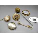 A XIX Century Hardstone Brooch, the polished oval panel collet set within foliate border; an oval