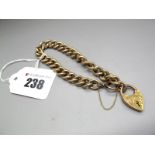 A 9ct Gold Curb Link Bracelet, of uniform design, to bolt ring, suspending 9ct gold heart shape