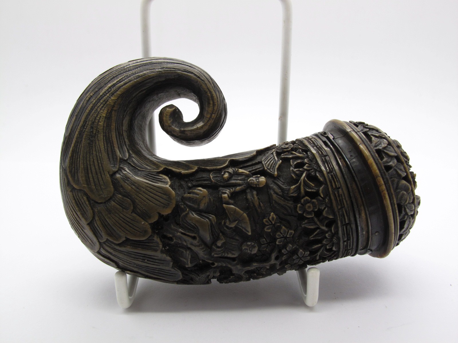 A Late XIX Century Chinese Horn Snuff Mull, heavily carved in relief with figures amongst trees